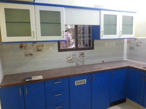 Elegant plywood modular kitchen with wooden finish cabinets and granite countertop in spacious apartment